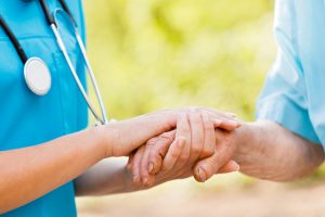 nurse helping an elderly man